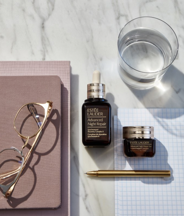 Skincare still life editorial lay-down showcasing product with lifestyle props