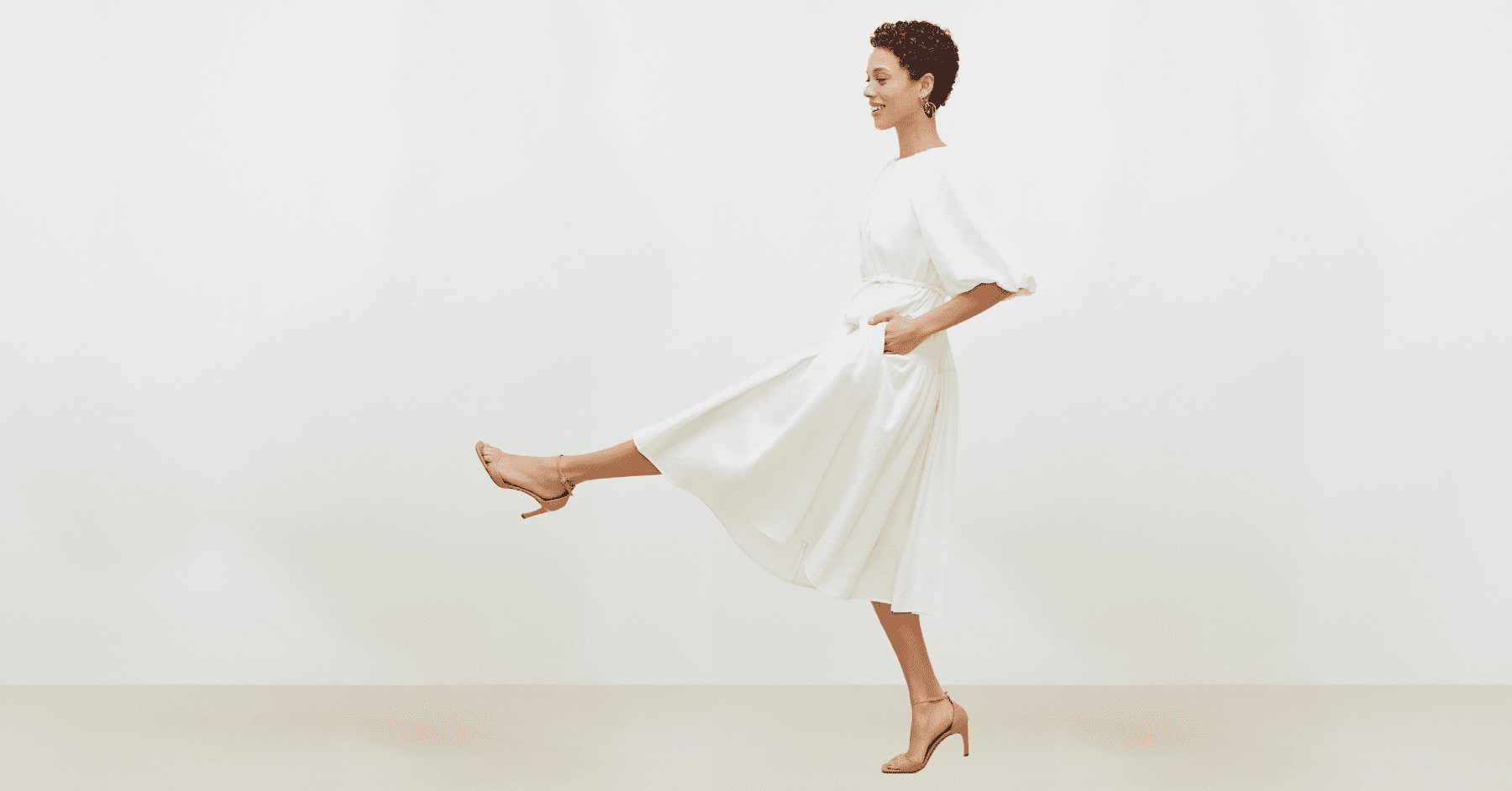 Black model in M.M.LaFleur white dress; a testament to creative director's vision for agile, cross-channel assets