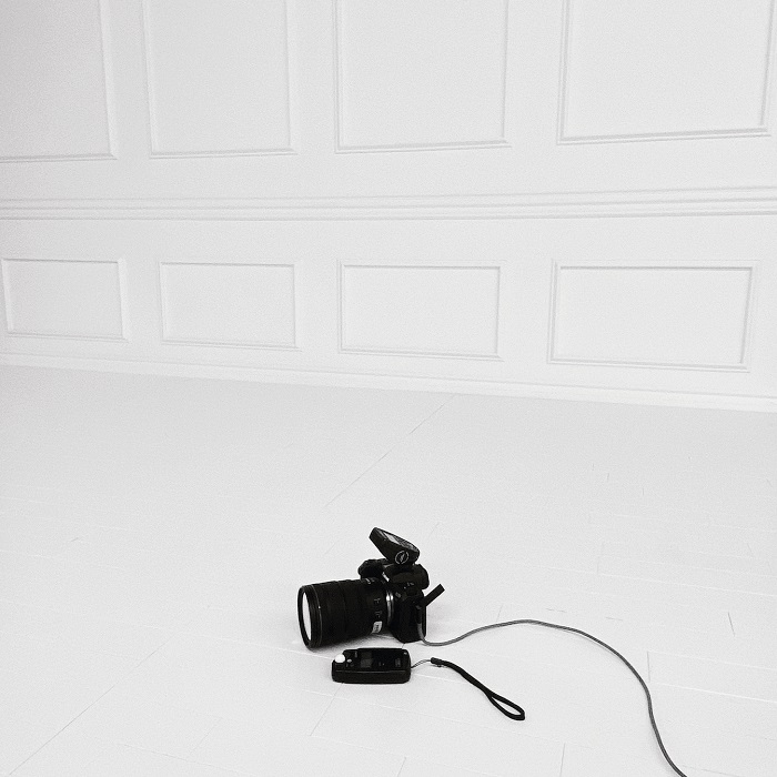A camera on a white set as BTS in a content production and photography studio