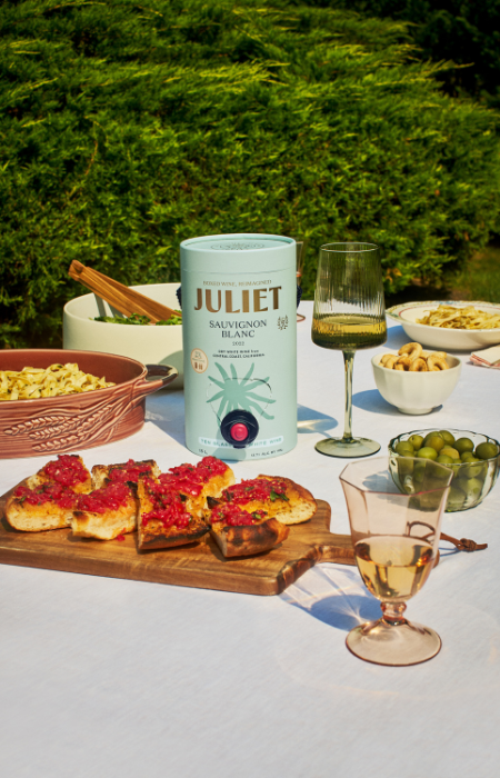 Editorial marketing still life photo of a Juliet Wine container on a table spread in sunlight