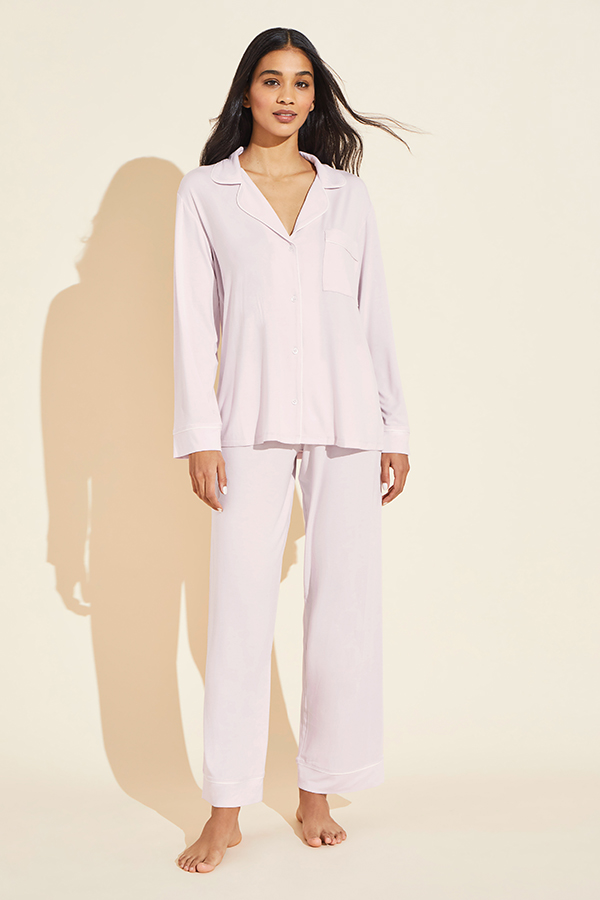 Complex on-figure image of a model in a plain light pink pajama set, pre-retouch