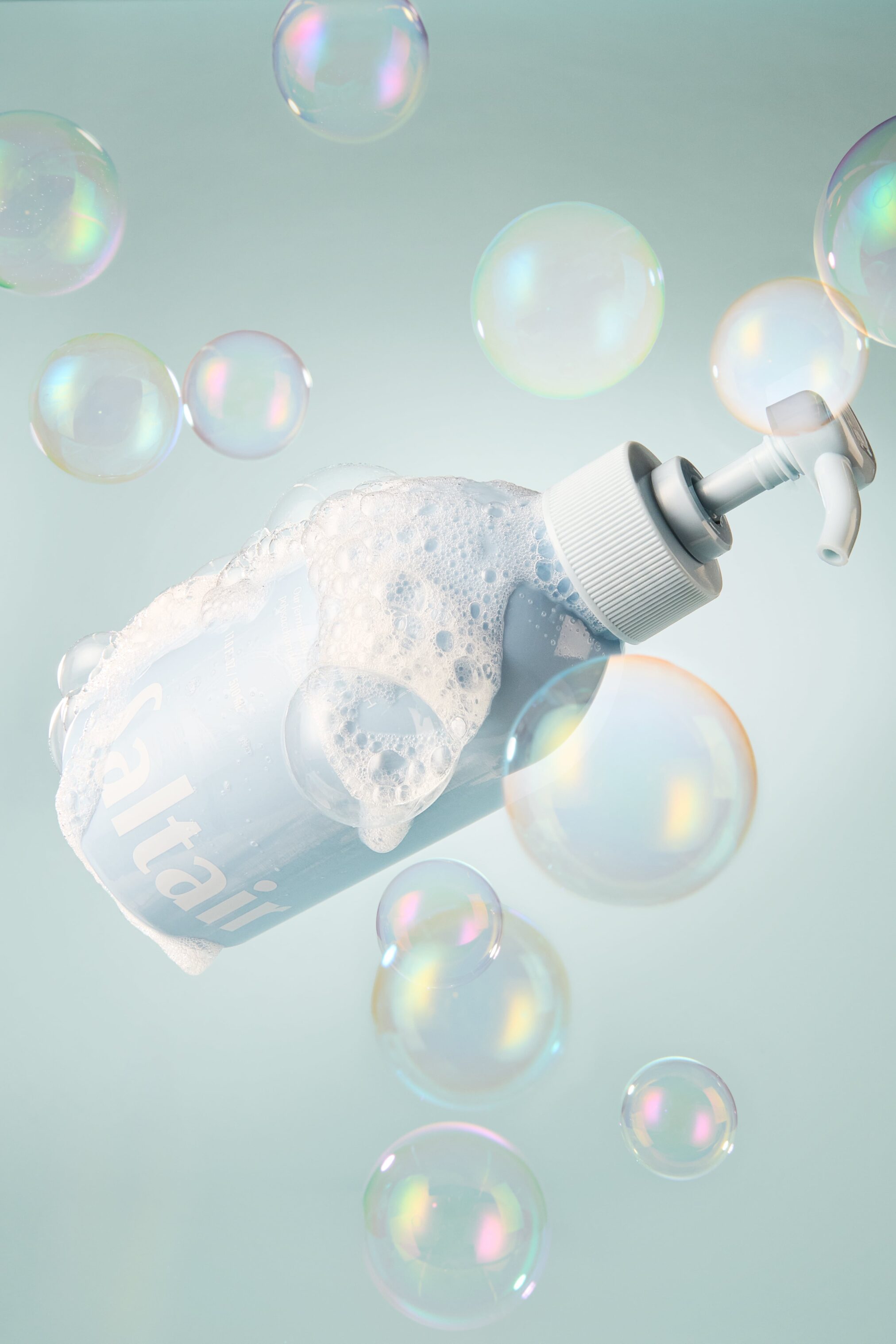 Creative still life of a sparkling Saltair bottle surrounded by floating bubbles