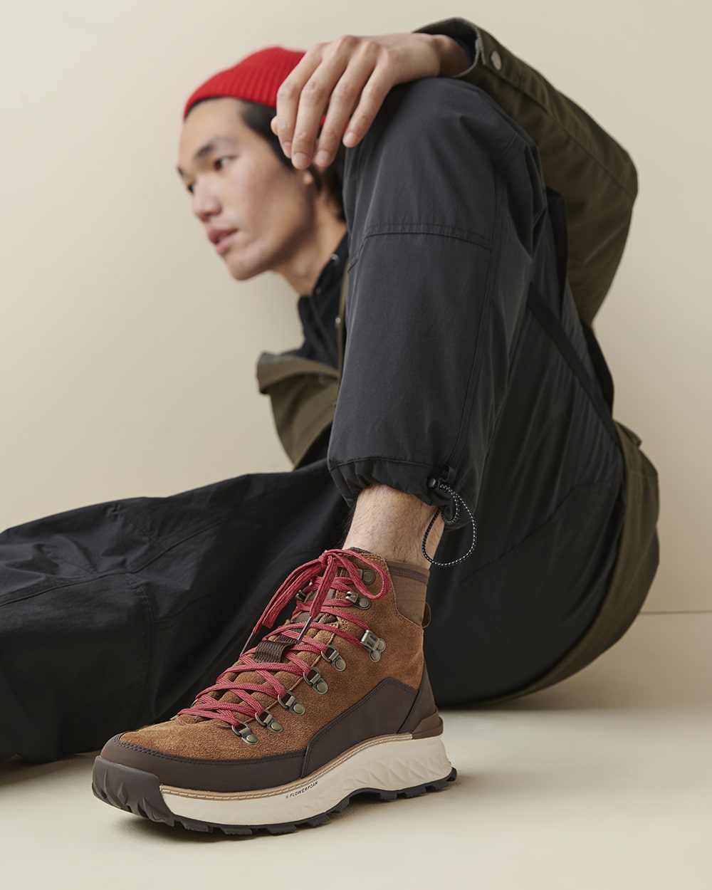 Fashion photography of a model wearing rugged outdoor boots, styled for casual exploration.