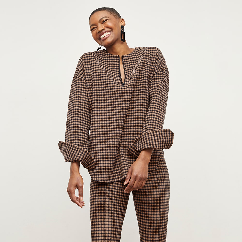 Fashion e-commerce photography featuring a model in a brown checkered jumpsuit, styled for a modern outfit.