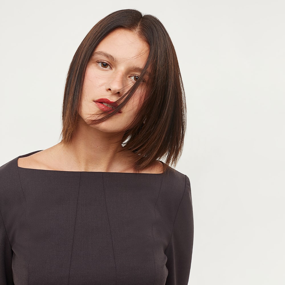 E-commerce portrait of a model in an off-the-shoulder top, emphasizing clean lines and modern style.